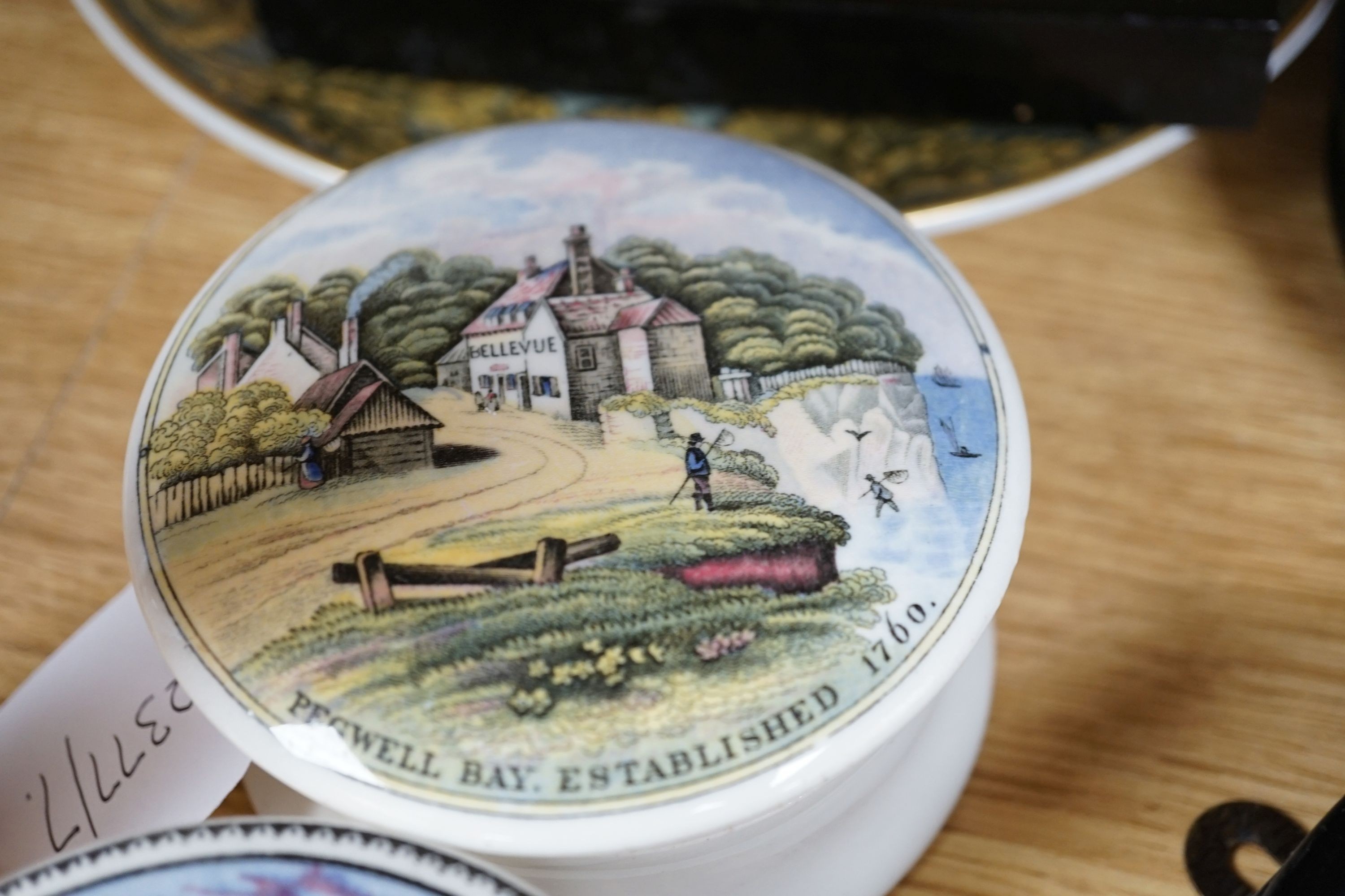 Seven Prattware pot lids, mounted in ebonised wood frames, an F & R Pratt plate and two pot lids with bases